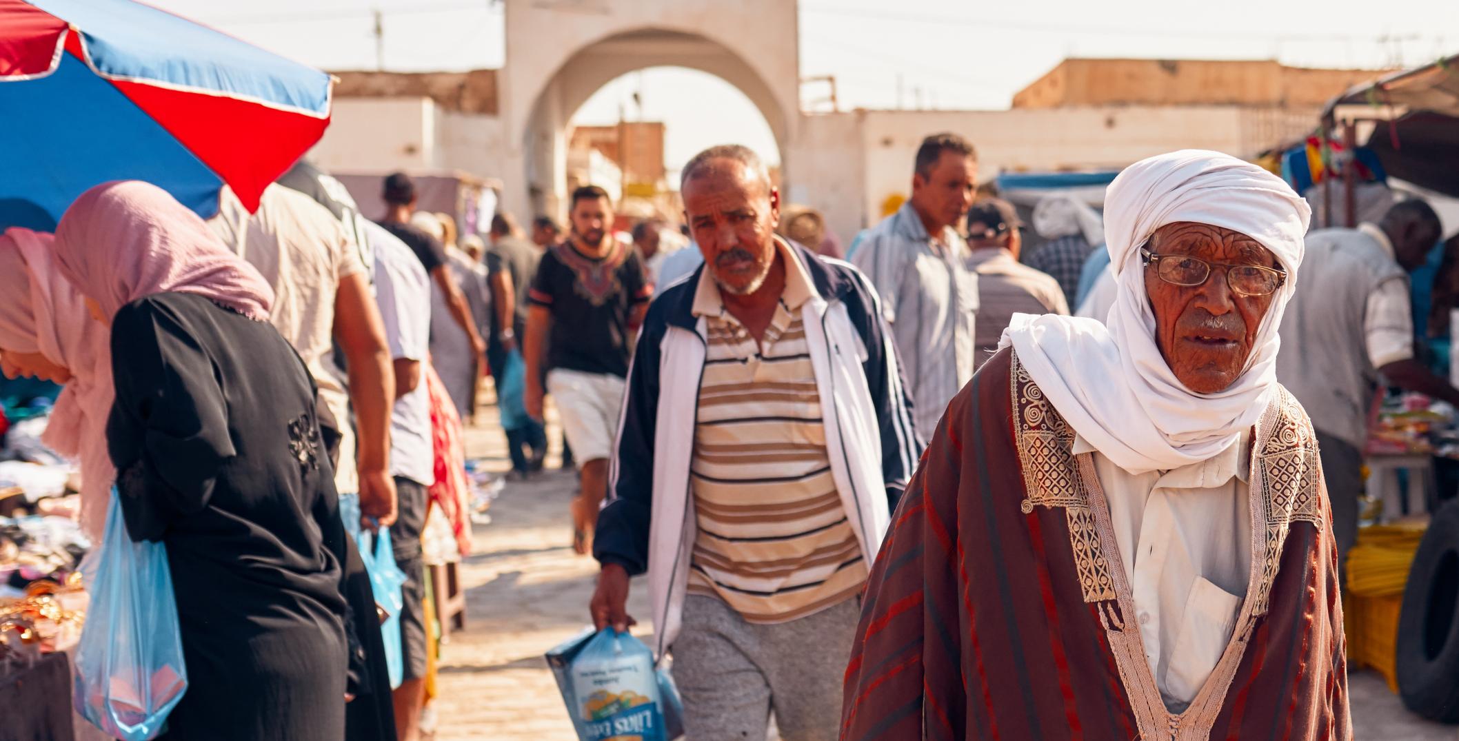 Men in traditional Tunisian clothes in Douz market, Tunisia