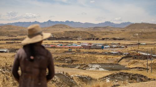 Woman facing the copper mining area in Peru
