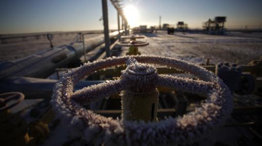 Ice sits on a valve control wheel connected to pipe work at a natural gas field in Russia