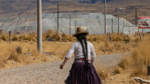 Woman walking toarda a copper mine in Challhuahuacho, Peru
