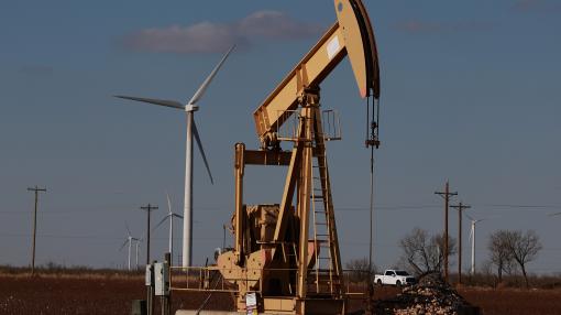 Oil pumpjack with wind turbines in the oil field