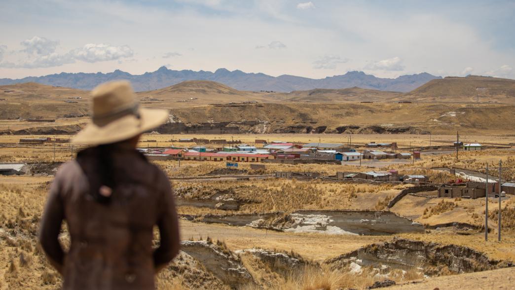 Woman facing the copper mining area in Peru