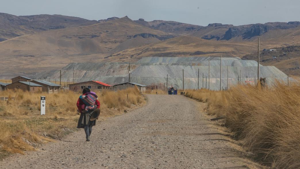 Woman walking towards a mining site in Peru