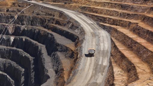 Two trucks transport gold ore from open cast mine, Australia